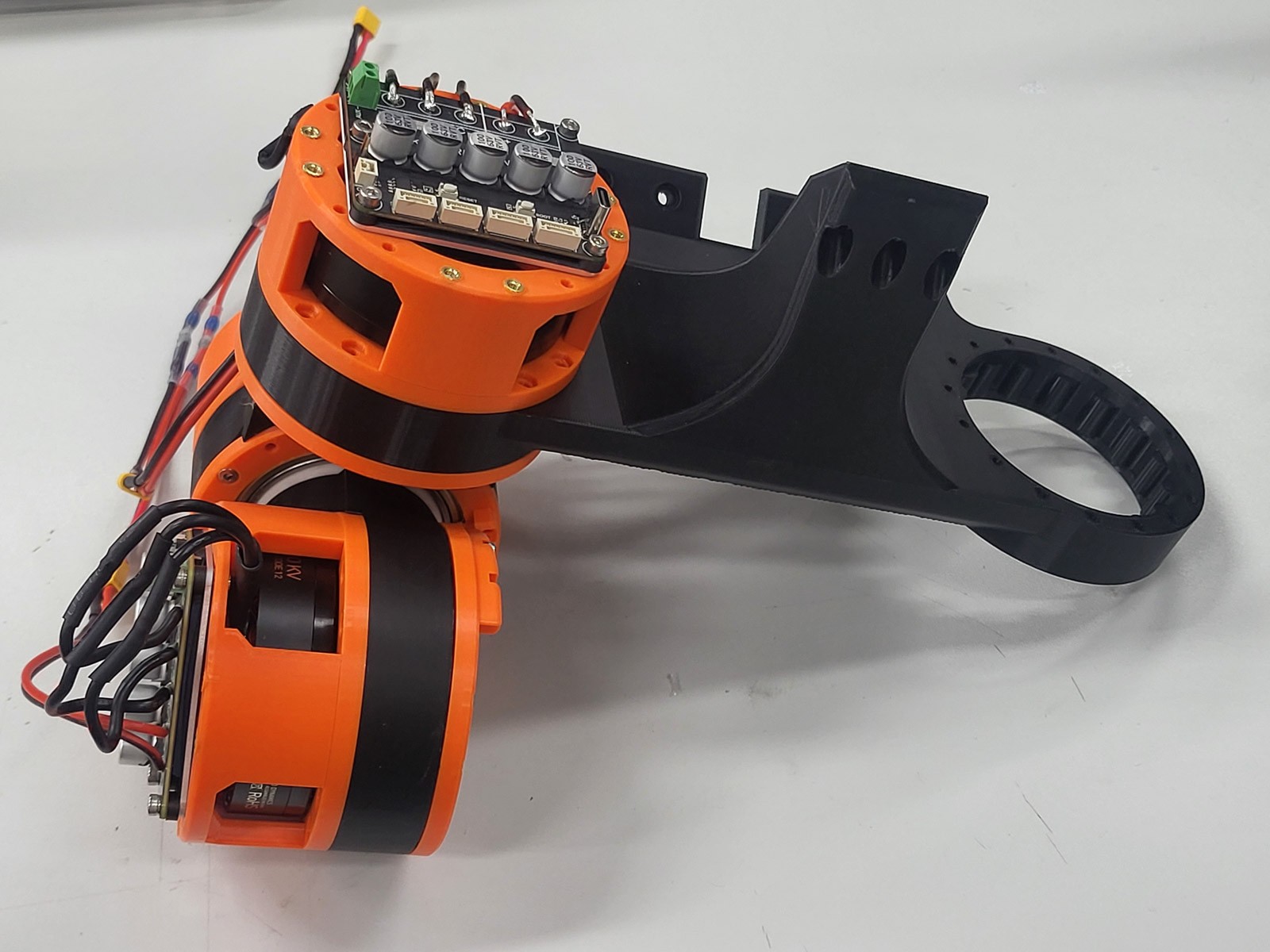Two hip actuators with XDrive MINI driver boards, attached to a black 3D-printed hip structure part.